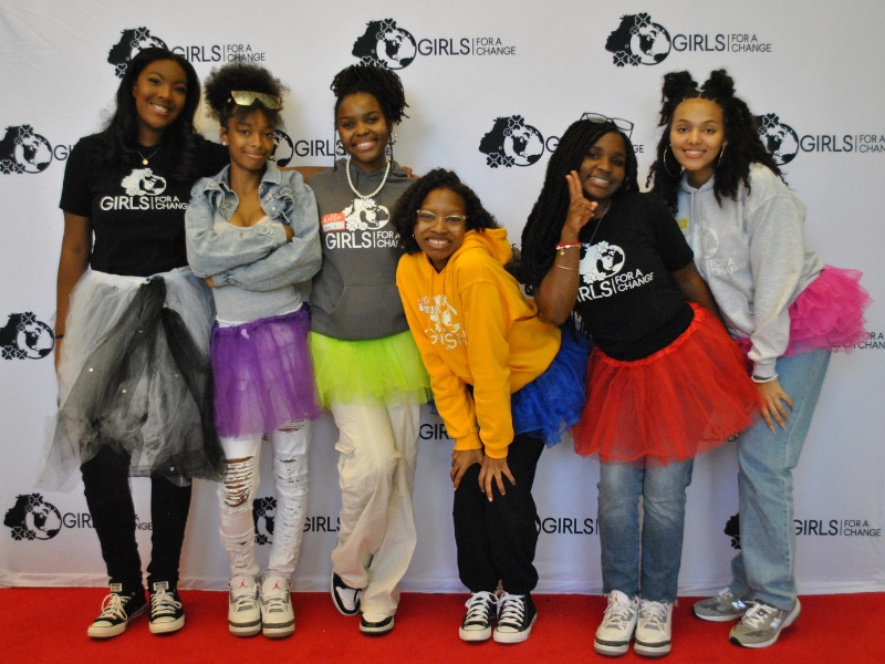 five young Black girl Peer Advisors wear tutus and pose for a photo