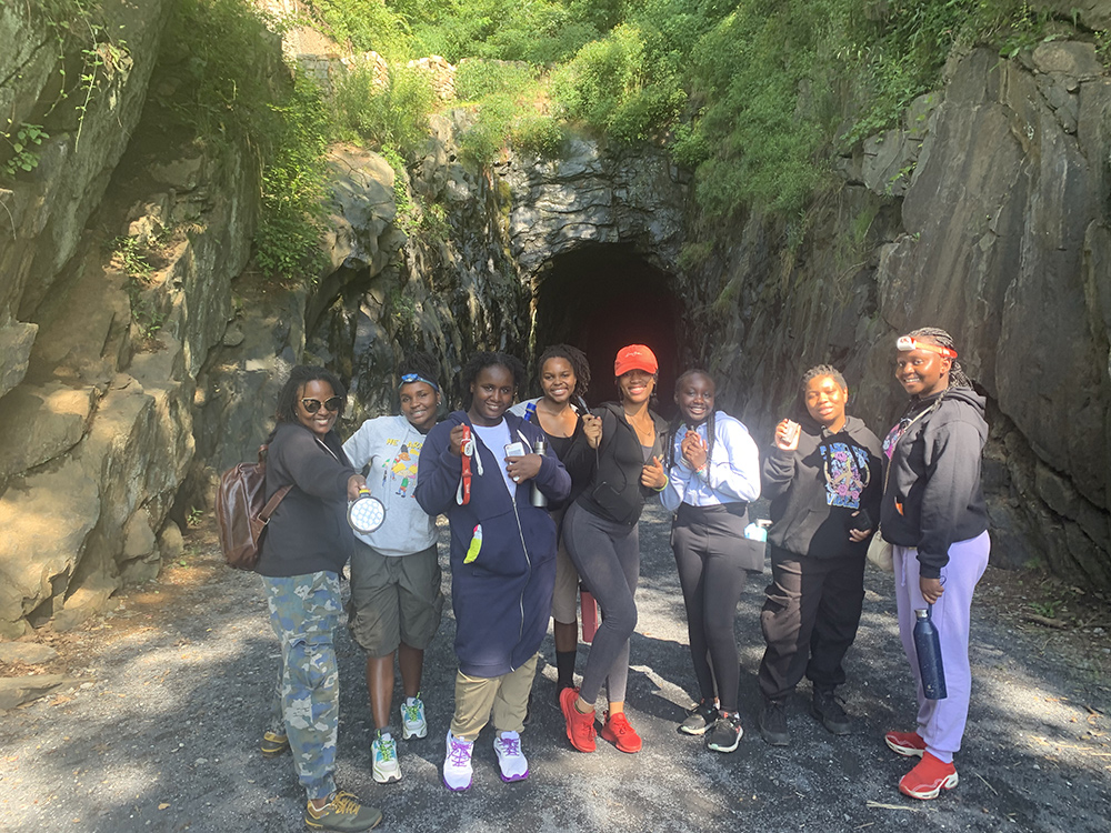 Group of Black girls and their chaperones in the Girls For A Change Mission in Bloom program