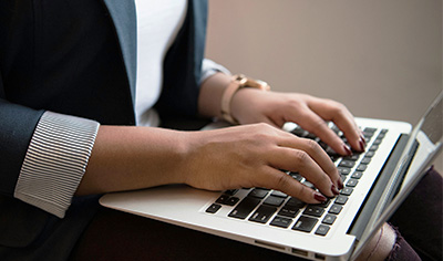 Black woman's hands on laptop