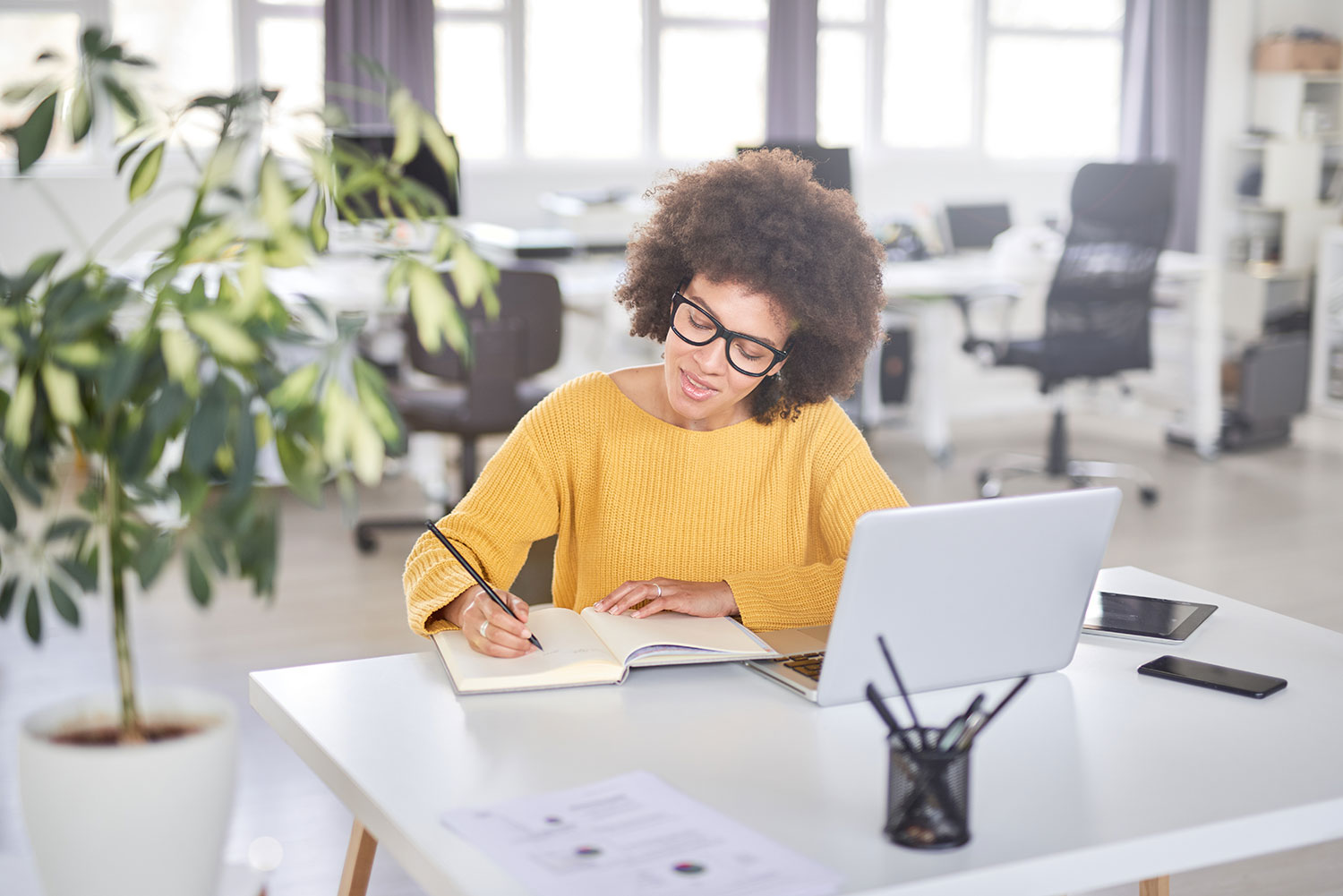 Smiling Black woman sitting at computer